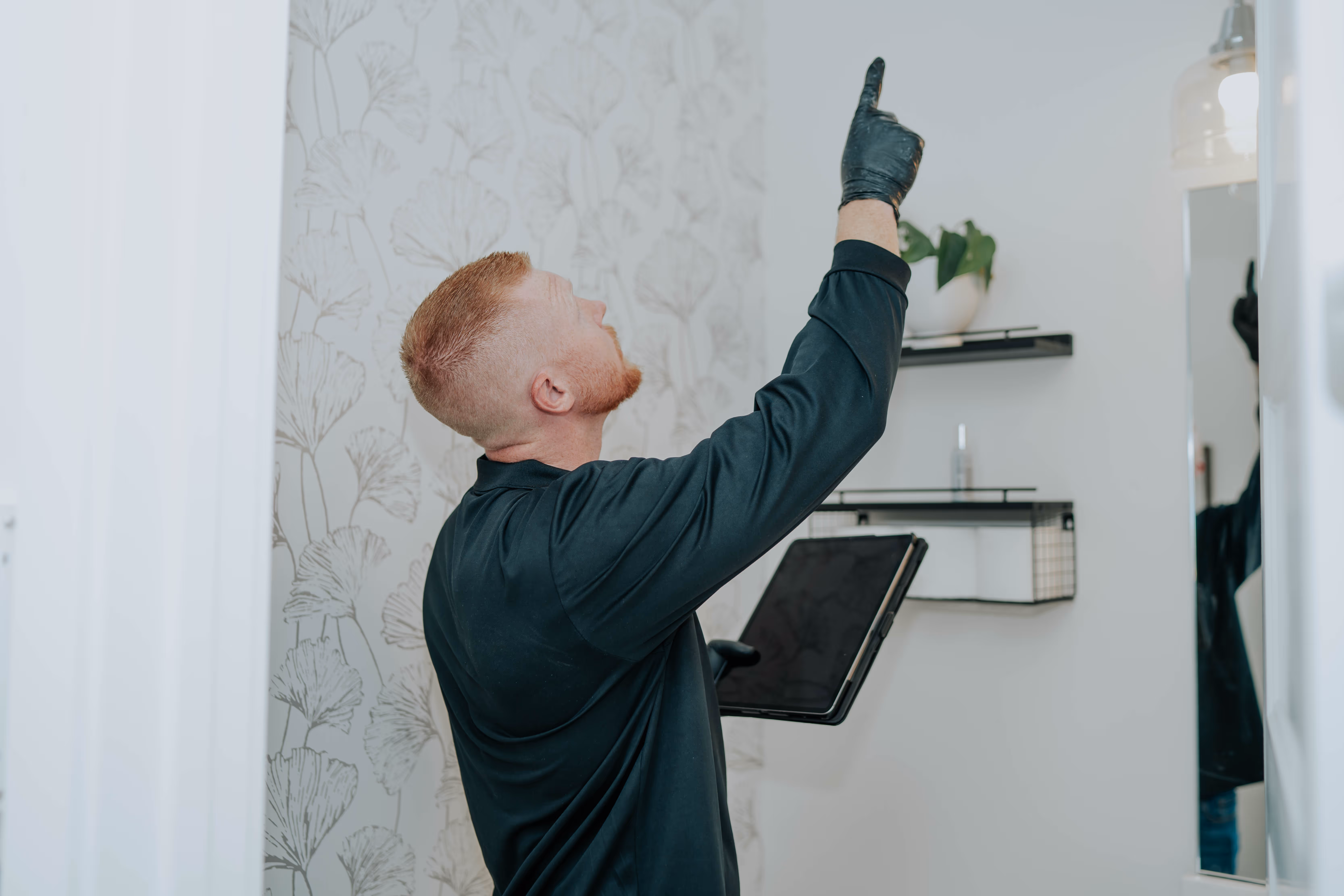 EnviroPure Mold Services inspector assessing a wall with diagnostic tools